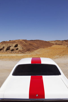 Rear View Of Muscle Car In Desert