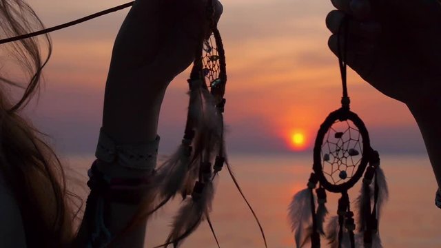 Hippie Friends with Dreamcatchers at Sunset Beach by Sea
