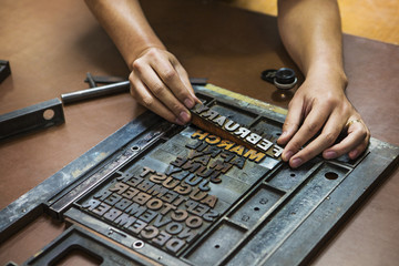 Close-up of woman working with letterpress