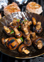 roasted mushrooms in pan on barbecue