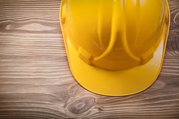 Safety building helmet on wooden board construction concept