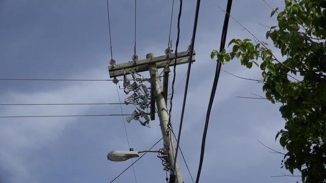 Wooden electric pillar with wires & lamp.