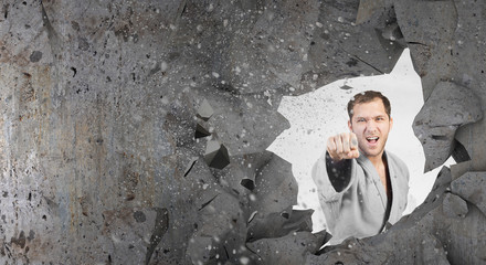 Man in kimono breaking wall