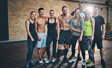 Group of eight athletic young adults in gym