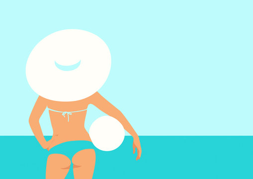 Woman in a white hat standing at the beach holding a ball