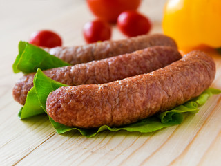 sausage with vegetables served on a wooden board