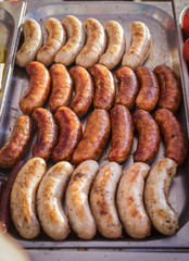 Sausages laid out on a baking sheet