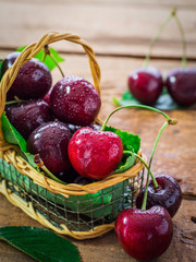 Cherries In a Basket On  a Wooden Table