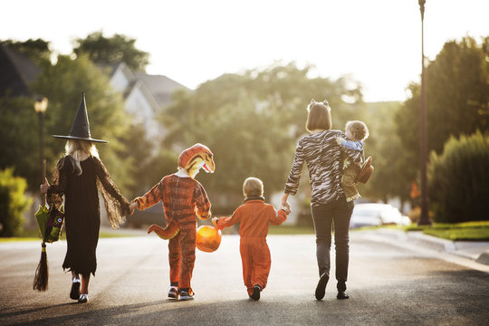 Rear view of a family dressed up in costume for Halloween