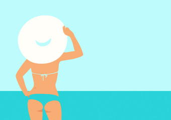 woman holding a white hat standing at the beach