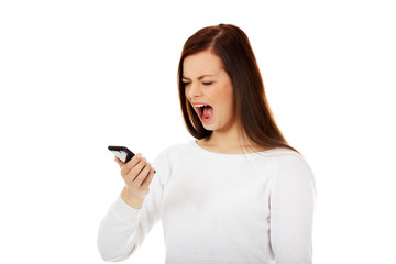 Naklejka premium Young student woman yelling to the mobile phone