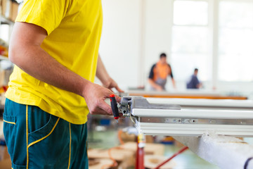 Manual worker assembling PVC doors and windows. Manufacturing jobs. Selective focus. Factory for aluminum and PVC windows and doors production.