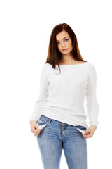 Fototapeta premium Sad young woman with empty pockets