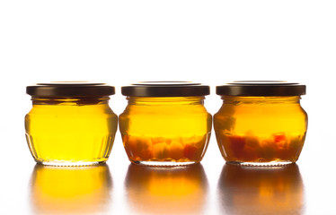 Bright yellow jam - dandelion flower honey in glass jars on whit