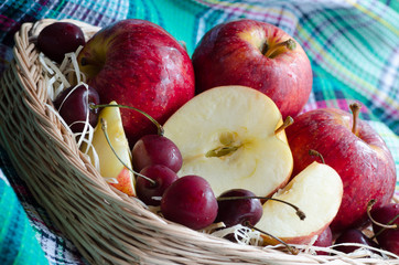 Red apples and cherry on a towel

