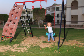 little girl on a swing