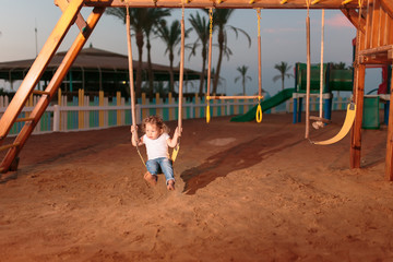 little girl on a swing