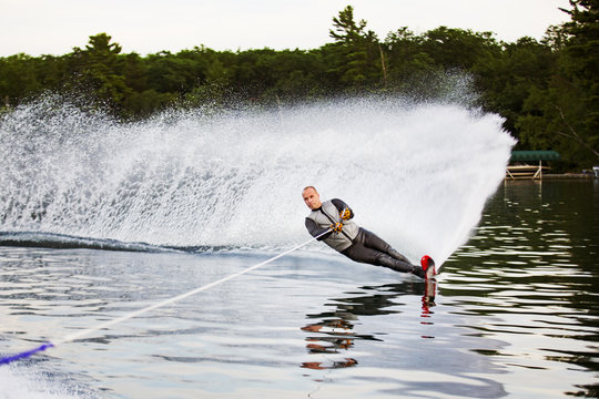 Man waterskiing on lake