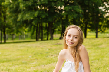 Outdoors portrait of beautiful young girl looking at you.