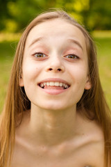 Fototapeta premium Outdoors portrait of beautiful young girl looking at you.