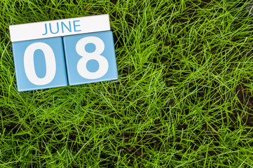 June 8th. Image of june 8 wooden color calendar on greengrass lawn background. Summer day, empty space for text