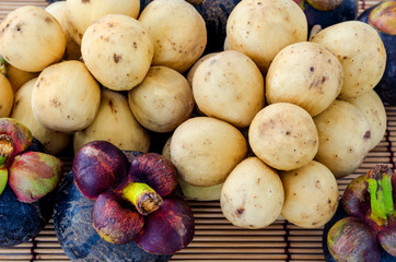 Wollongong and mangosteen delicious fruit on bamboo background,