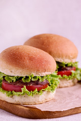 Burger with beef, tomato and herbs.