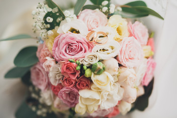 Pretty good wedding bouquet of various flowers with rings