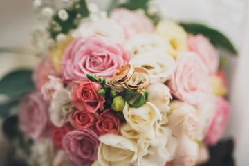 Pretty good wedding bouquet of various flowers with rings