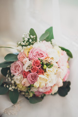 Pretty good wedding bouquet of various flowers with rings