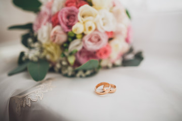 Pretty good wedding bouquet of various flowers with rings