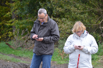Couple hiking with gps in countryside