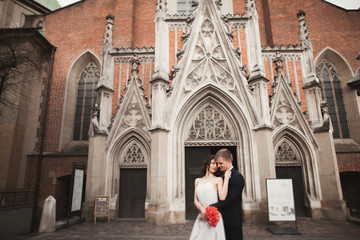 Fototapeta na wymiar Wedding couple, bride and groom near a church in Krakow