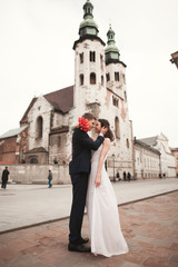 Wedding couple, bride and groom near a church in Krakow