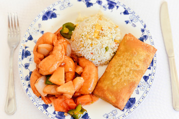 Oriental rice with sea food and hands hold fork knife close up photo