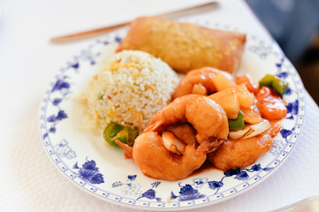 Oriental rice with sea food and hands hold fork knife close up photo