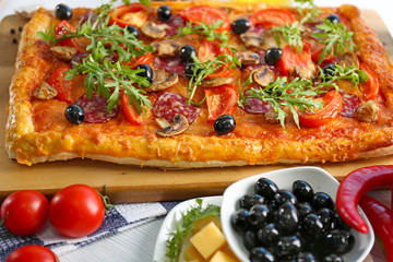Rectangle delicious pizza and vegetables on the table