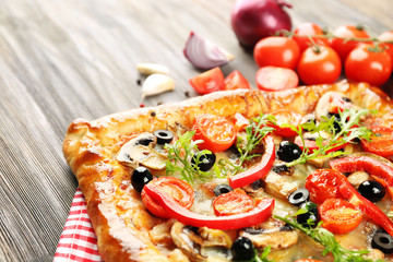 Freshly homemade pizza on wooden table closeup
