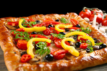 Freshly homemade pizza on black background