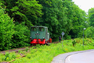 Naklejka premium A train and a railroad worker on a village railway