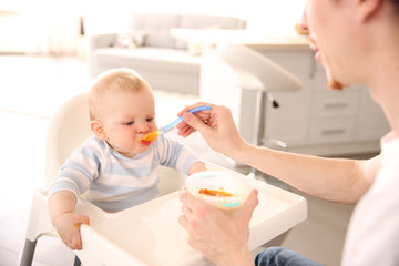 Father feeding his baby son