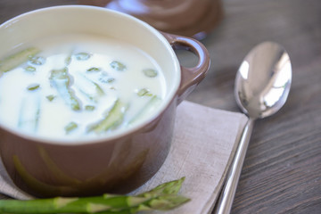 Asparagus soup on wooden table