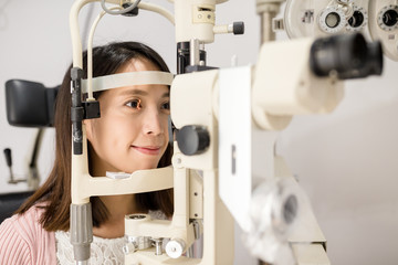 Woman doing eye test in medical office