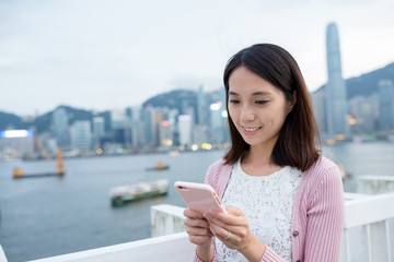 Fototapeta premium Woman hold cellphone at Hong Kong