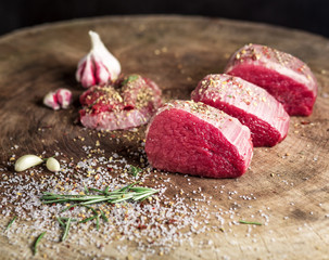 Juicy raw beef steak on wooden table