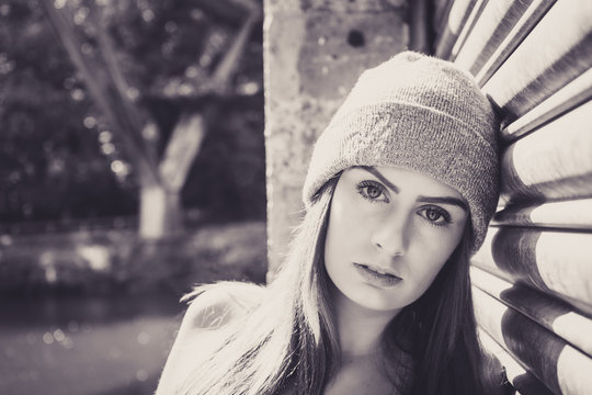 Portrait of beautiful young female model, leaning against garage