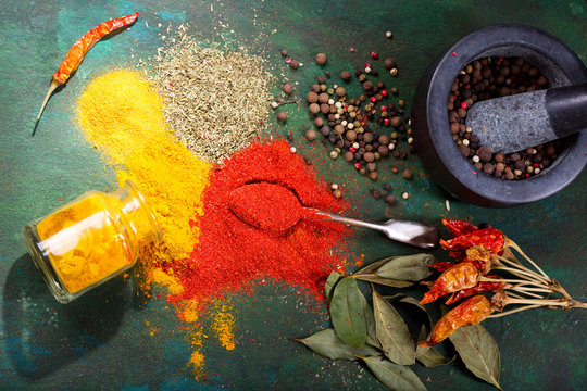 various spices on green background