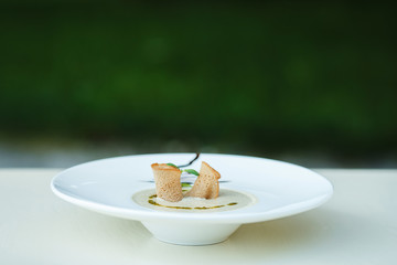 Cream soup with mushrooms and watercress salad. Soup decorated with croutons and watercress salad.