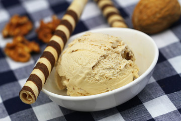 Walnut ice cream with chocolate wafers on checkered cloth
