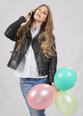 girl model in studio with balloons and cell phone